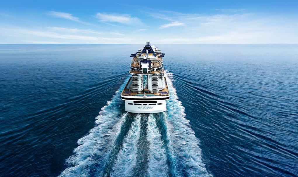 A modern cruise ship navigating through calm blue waters | MSC Cruises