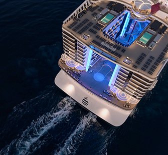Aerial view of a modern cruise ship with illuminated pools and lounges | MSC Cruises