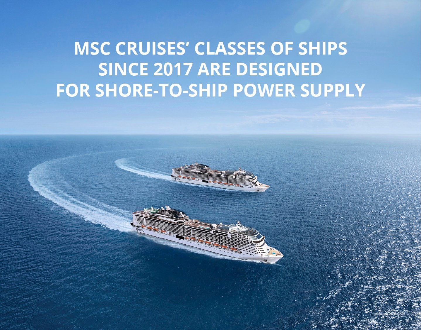 Two MSC cruise ships sailing in open blue waters under a sunny sky | MSC Cruises Two MSC cruise ships sailing in open blue waters under a sunny sky | MSC Cruises
