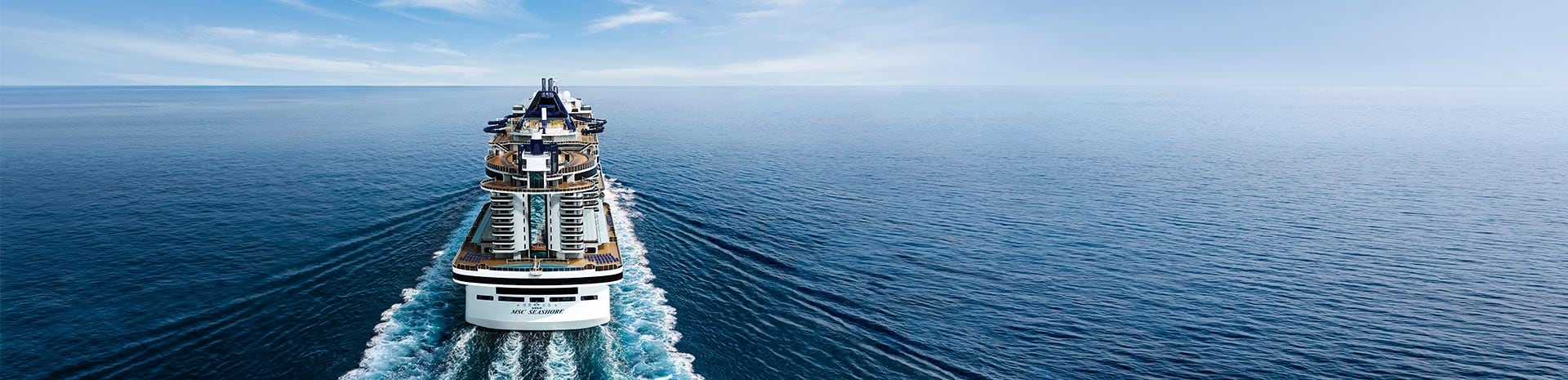 A modern cruise ship navigating through calm waters | MSC Cruises A modern cruise ship navigating through calm waters | MSC Cruises