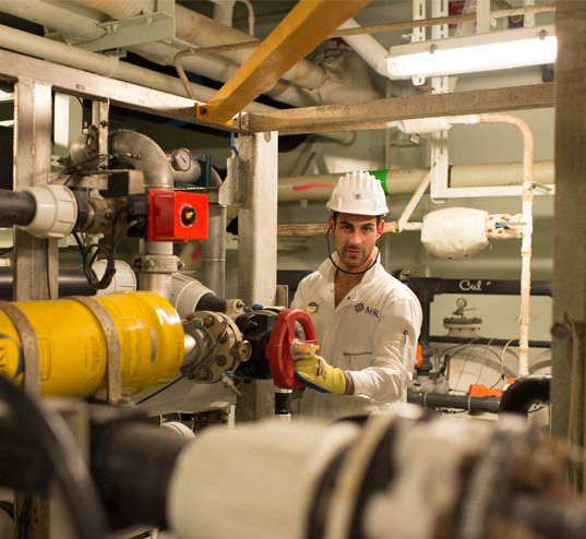 A crew member operating machinery in the engine room of an MSC cruise ship | MSC Cruises A crew member operating machinery in the engine room of an MSC cruise ship | MSC Cruises