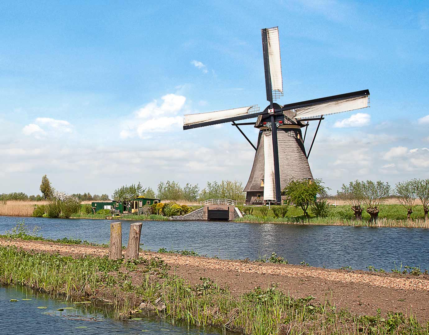 A scenic windmill by a tranquil canal in the Netherlands | MSC Cruises