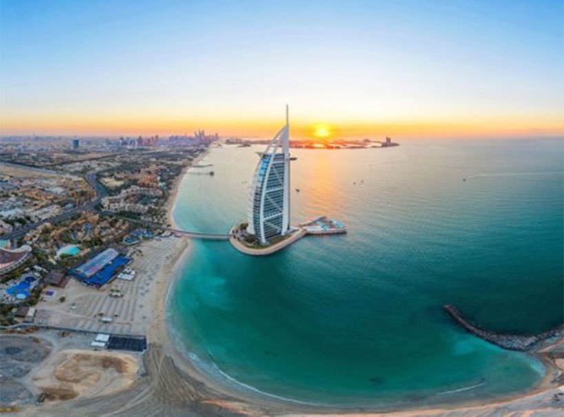 The Burj Al Arab and Dubai coastline at sunrise, a stunning destination for cruises | MSC Cruises