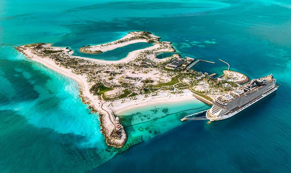 Aerial view of a cruise ship docked at a tropical private island with turquoise waters | MSC Cruises Aerial view of a cruise ship docked at a tropical private island with turquoise waters | MSC Cruises
