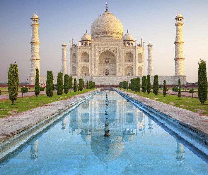 The Taj Mahal with its reflection in a serene pool at sunrise | MSC Cruises