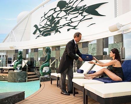 A guest enjoying poolside service on an MSC cruise ship deck | MSC Cruises A guest enjoying poolside service on an MSC cruise ship deck | MSC Cruises