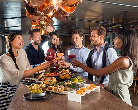 Guests enjoying a gourmet dining experience with wine onboard | MSC Cruises Guests enjoying a gourmet dining experience with wine onboard | MSC Cruises