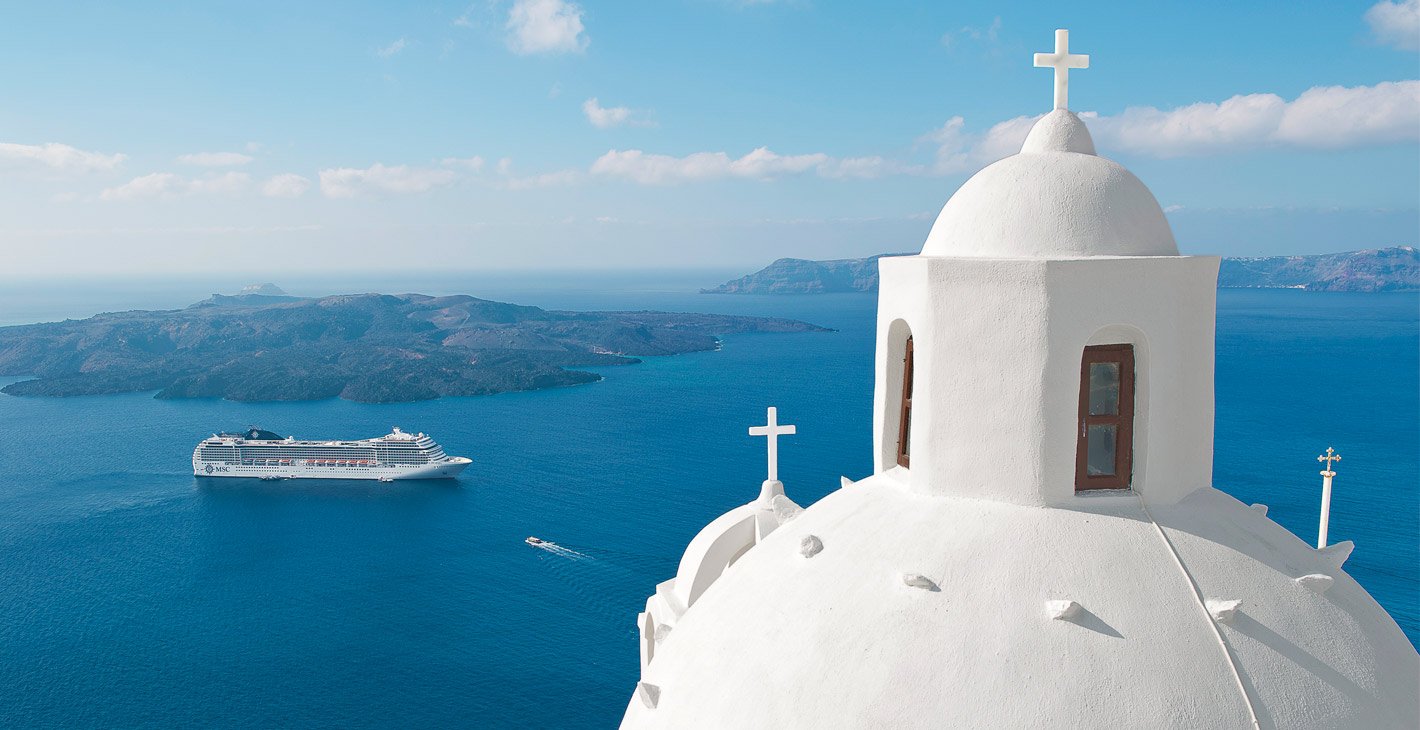 A white-domed church overlooking an MSC cruise ship near Santorini's blue waters | MSC Cruises
