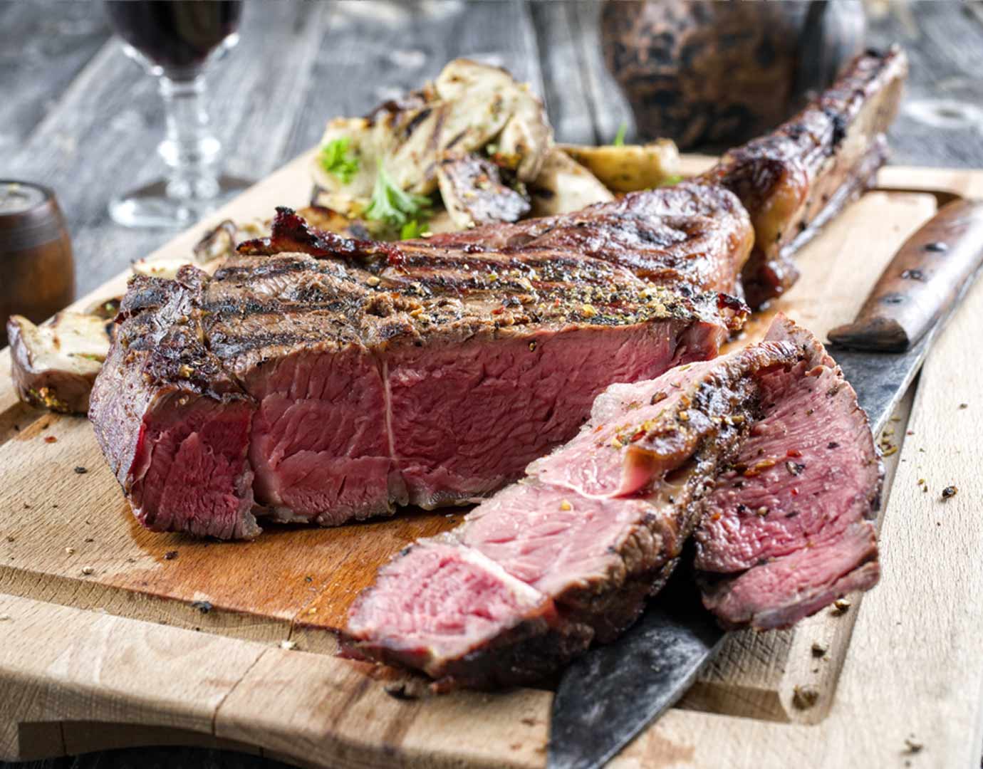 Juicy grilled steak served on a wooden board with roasted vegetables | MSC Cruises Juicy grilled steak served on a wooden board with roasted vegetables | MSC Cruises