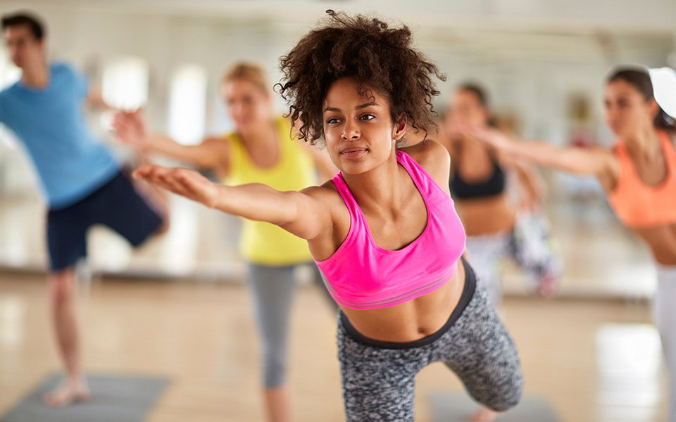 Guests enjoying a group fitness class in a bright studio onboard | MSC Cruises