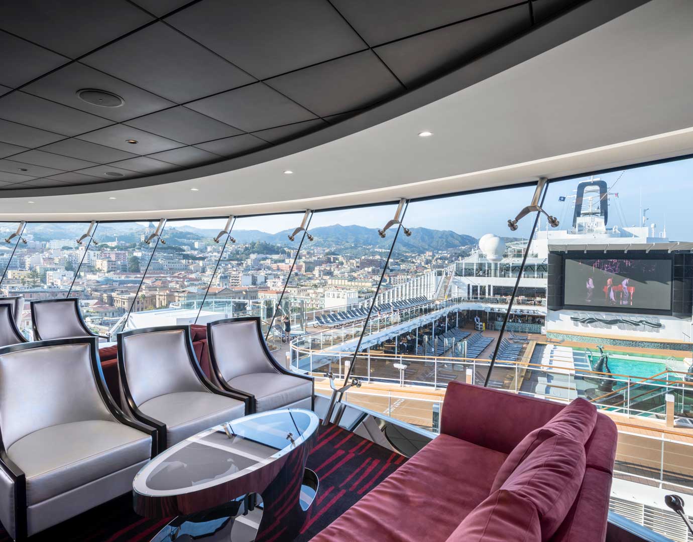 Luxurious lounge with panoramic views of a cruise ship and city skyline | MSC Cruises