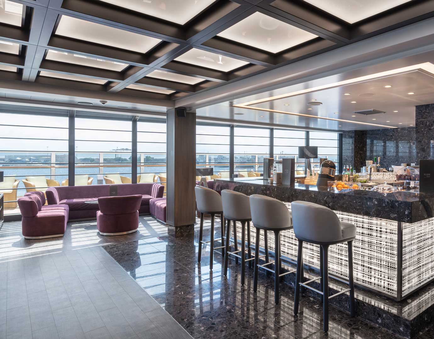Elegant lounge with plush seating and panoramic windows aboard MSC Seaview | MSC Cruises