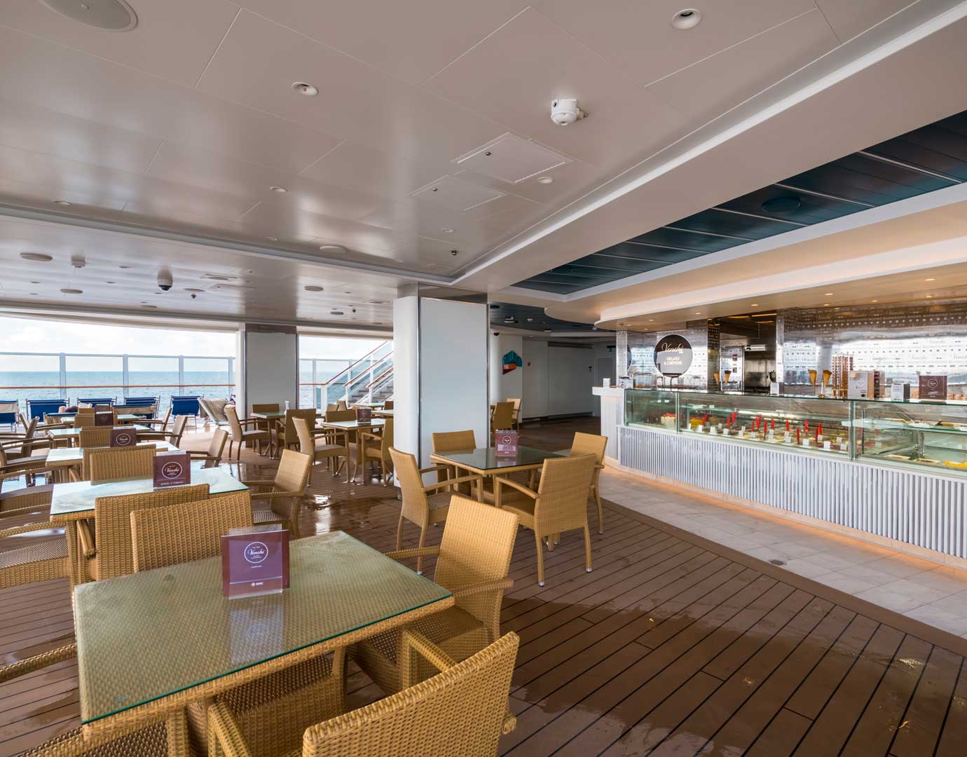 Outdoor gelato bar with wicker seating and ocean views on an MSC cruise ship | MSC Cruises