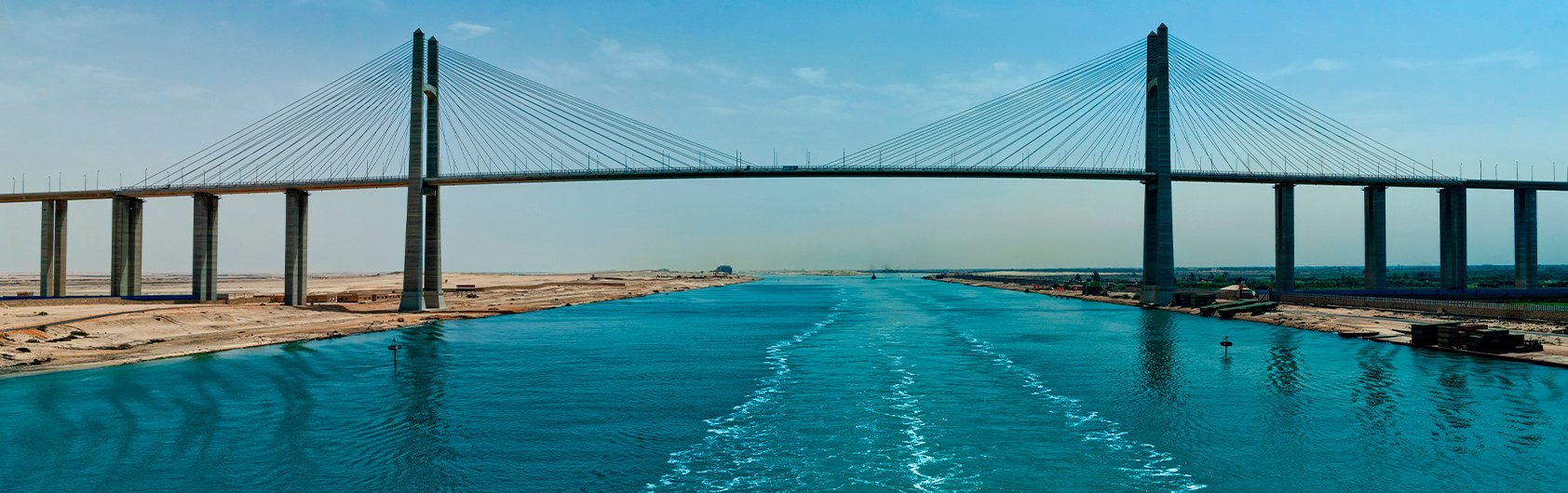 The Suez Canal with the Mubarak Peace Bridge under a clear blue sky | MSC Cruises